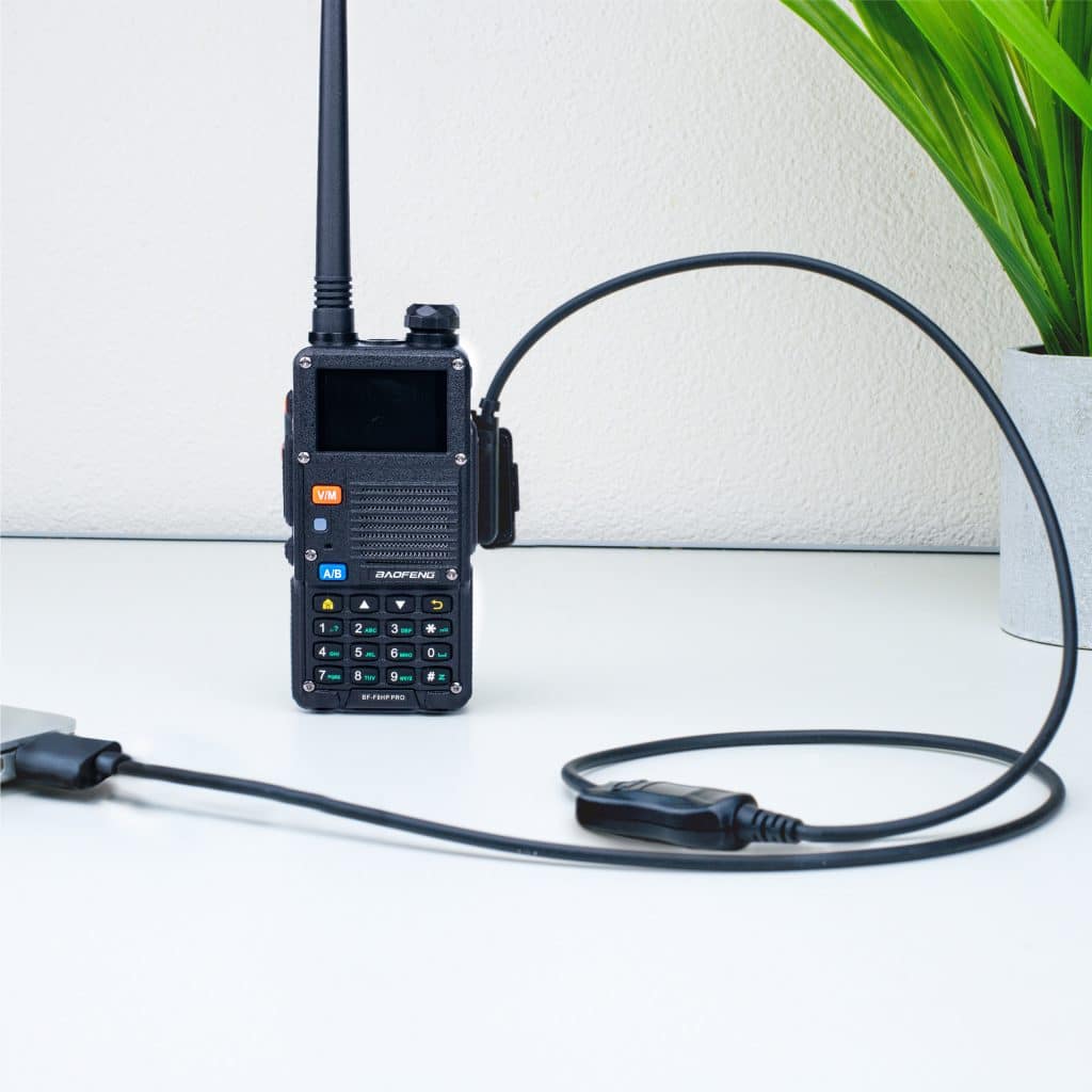 BTECH USB-C programming cable beside a handheld radio